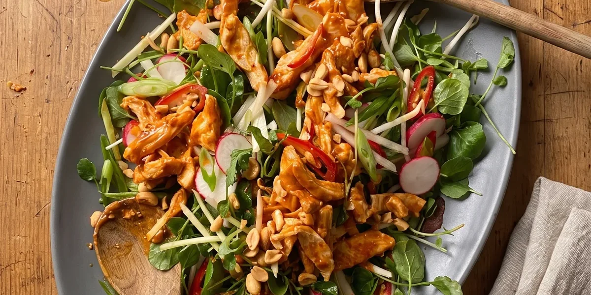 Gordon Ramsay bang bang chicken salad: shredded chicken in a chili peanut sauce over beansprouts, watercress, sliced radishes and red chili, topped with toasted peanuts