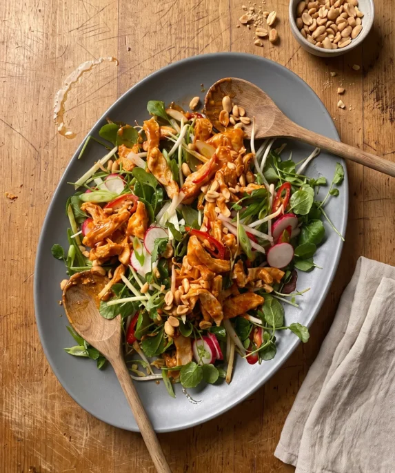 Gordon Ramsay bang bang chicken salad: shredded chicken in a chili peanut sauce over beansprouts, watercress, sliced radishes and red chili, topped with toasted peanuts