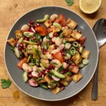 Gordon Ramsay butter bean salad: creamy butter beans, halved radishes, tomato, cucumber, pomegranate seeds, herbs and golden fried pita squares in a wide bowl