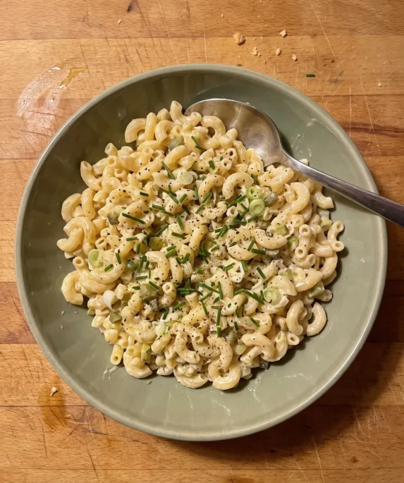 Gordon Ramsay creamy macaroni salad with crème fraîche, chives, scallions and diced cornichons in a bowl