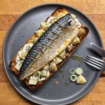 Gordon Ramsay mackerel and potato salad open sandwich: crisp-skinned mackerel fillet on warm potato salad with chives and scallions on toast
