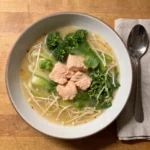 Gordon Ramsay miso salmon soup: a bowl of miso broth with flaked salmon, pak choi, broccoli and enoki mushrooms
