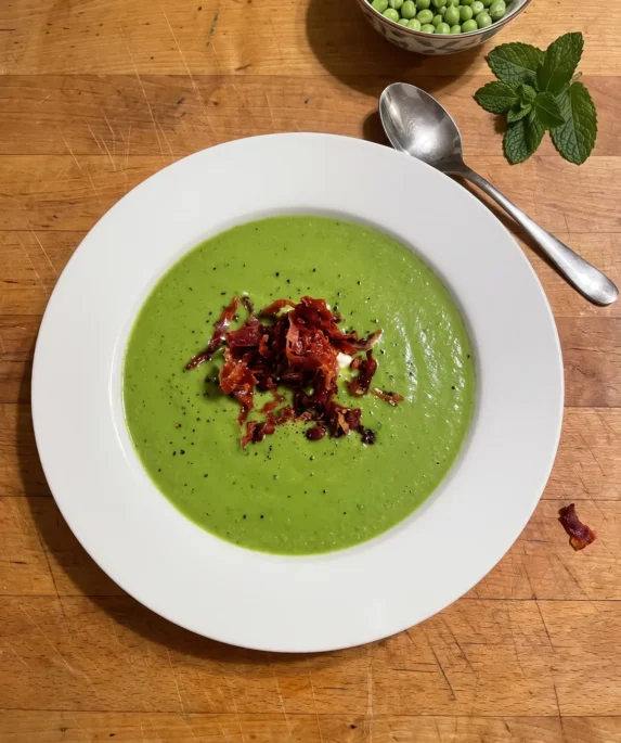 Gordon Ramsay pea and mint soup: a bowl of bright green pea soup with a dollop of crème fraîche and crispy Parma ham