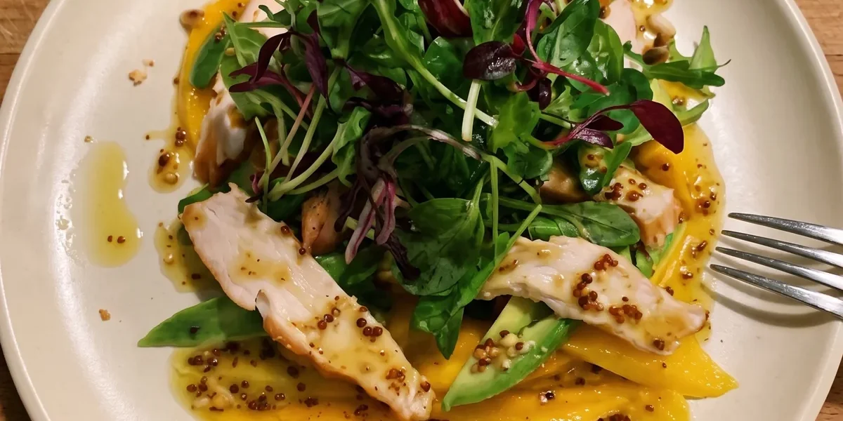 Gordon Ramsay mango, avocado and smoked chicken salad: sliced mango, avocado strips and smoked chicken under a pile of mixed leaves with a wholegrain mustard dressing