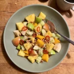 Gordon Ramsay spicy fruit salad: pineapple, green apple, pear, mango and cucumber in a tamarind chili dressing with crushed peanuts and red chili
