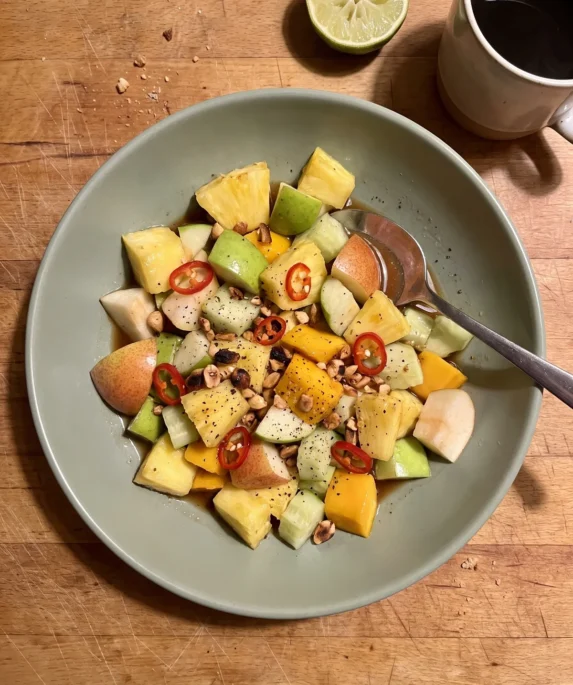 Gordon Ramsay spicy fruit salad: pineapple, green apple, pear, mango and cucumber in a tamarind chili dressing with crushed peanuts and red chili