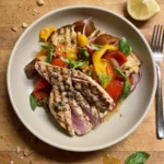 Gordon Ramsay tuna salad: sliced seared tuna steak, rare in the middle, over a panzanella of torn toasted sourdough, heirloom tomatoes, roasted peppers, red onion and basil with capers